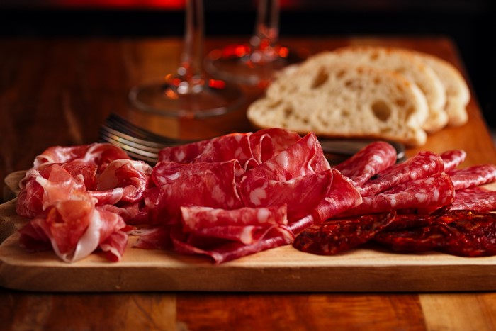 Charcuterie board with sliced meats and bread