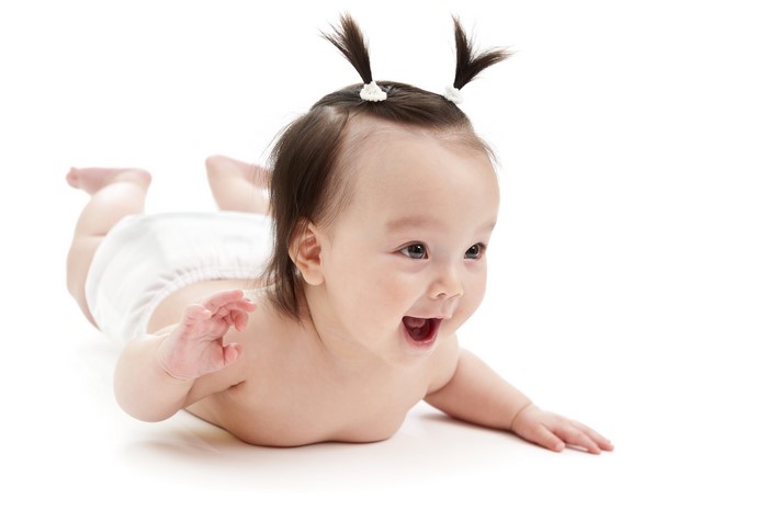 Baby girl with pigtails on white background