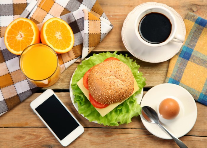Breakfast with coffee, juice, sandwich, and egg