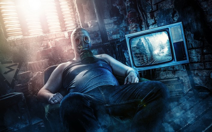 Man in gas mask sitting in a ruined room