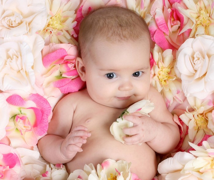 Infant surrounded by roses