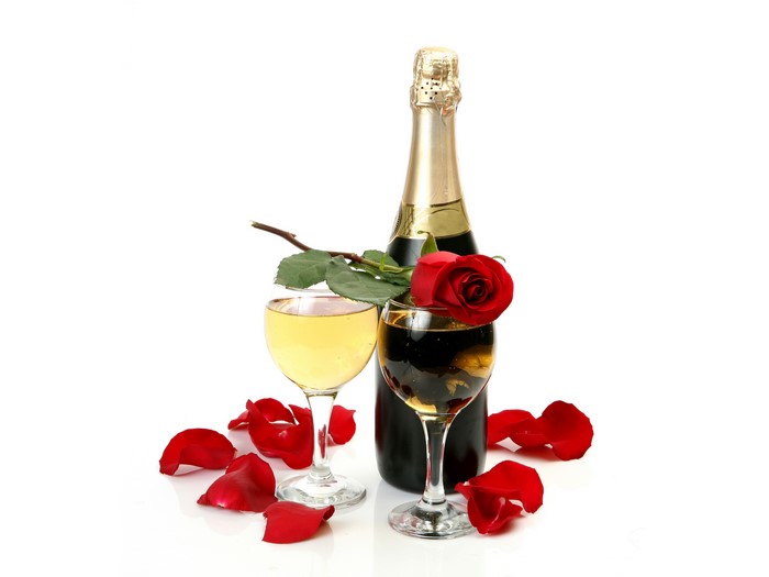 Champagne bottle, wine glasses, rose, and petals
