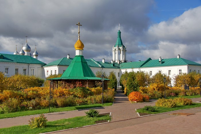 Orthodox monastery with green roofs and autumn foliage in Russia