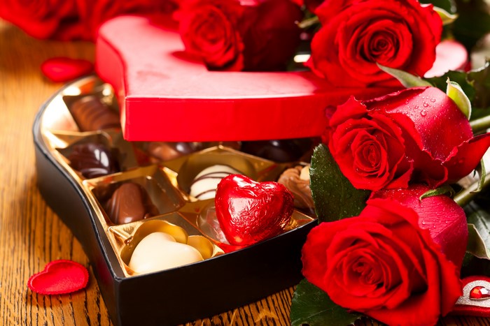Heart-shaped box of chocolates with red roses