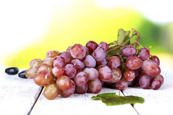 Red grapes on a wooden table