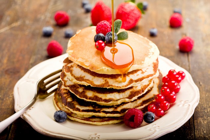 Stack of Pancakes with Berries and Honey