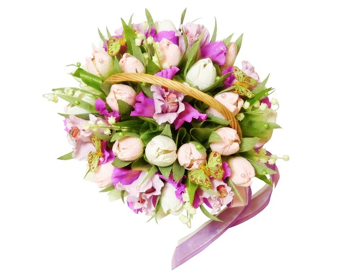 Handmade bouquet of tulips and lilies of the valley in a basket