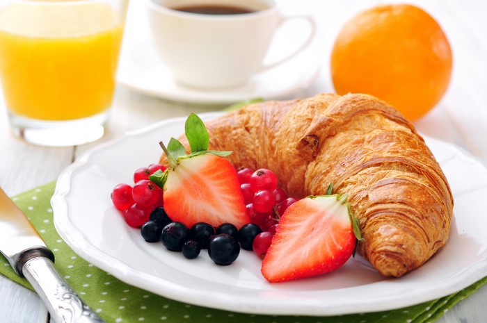 Croissant with berries and orange juice