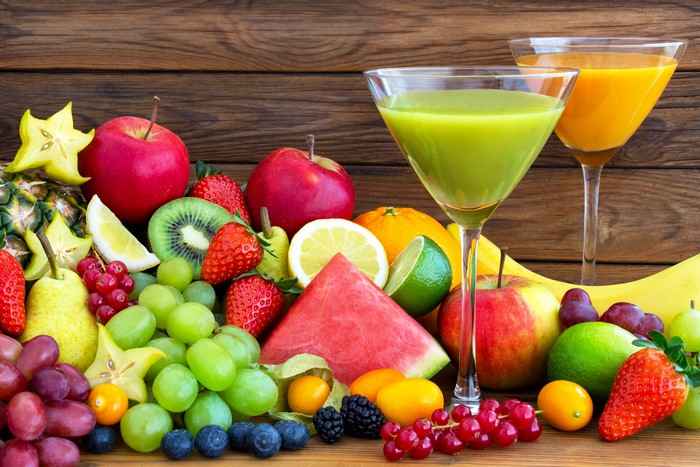 Assortment of Fresh Fruits and Juices in Glasses