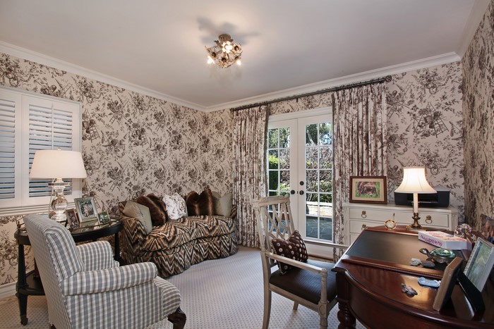 Living room with sofa, armchair, and desk