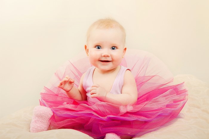 Baby girl in pink tutu smiling
