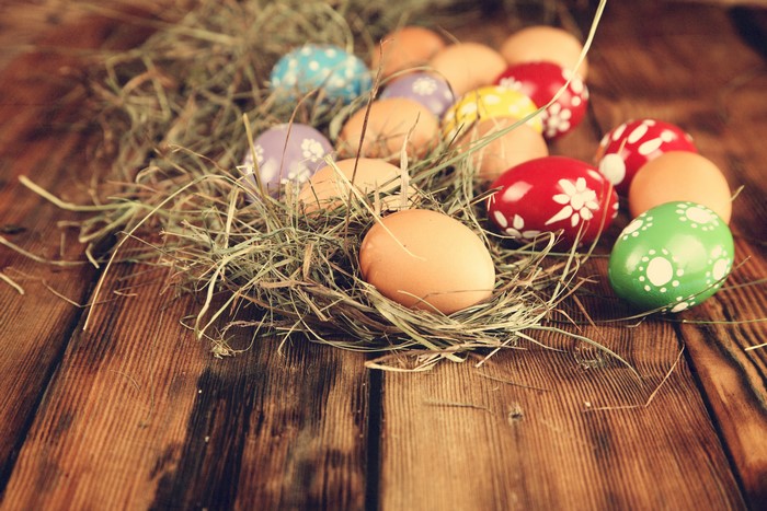 Easter Eggs in Hay on Wooden Table
