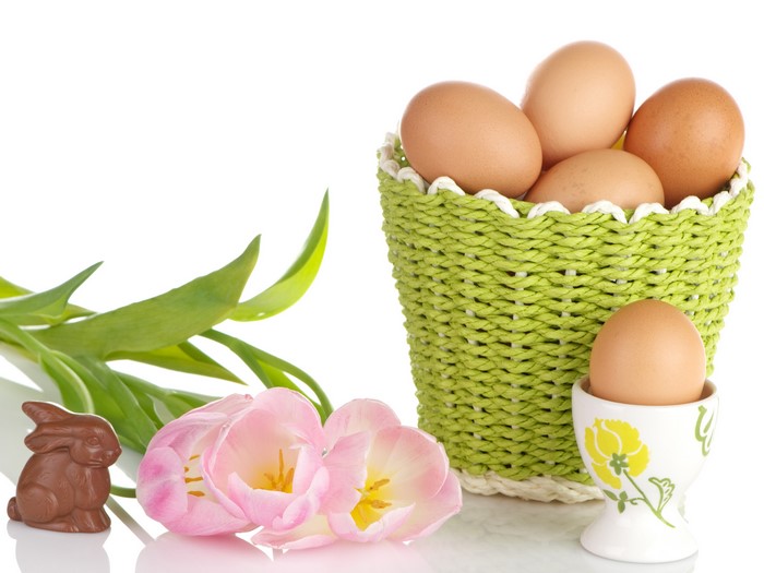 Easter Eggs in Wicker Basket with Chocolate Rabbit and Tulips