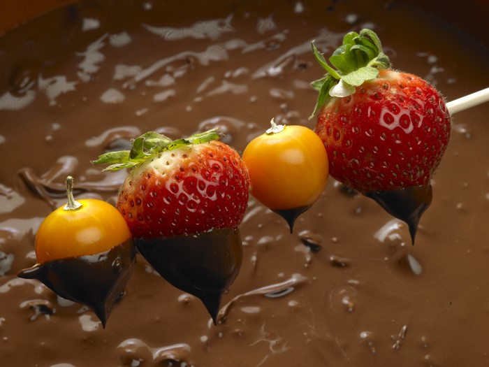Strawberries and golden berries dipped in chocolate