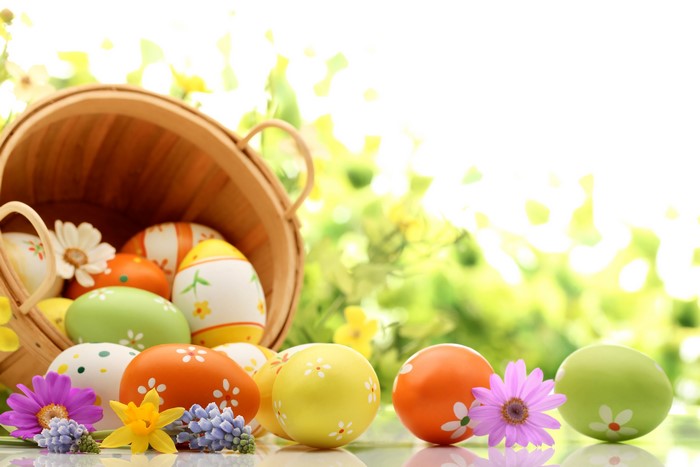 Easter Eggs in a Wicker Basket with Flowers