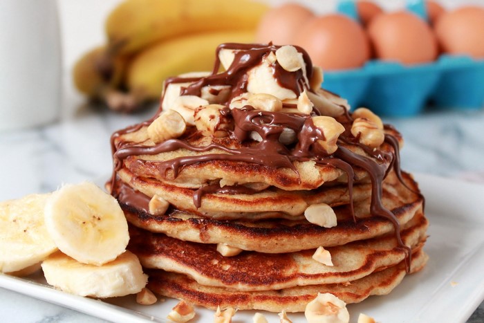 Stack of Banana Pancakes with Chocolate and Hazelnuts