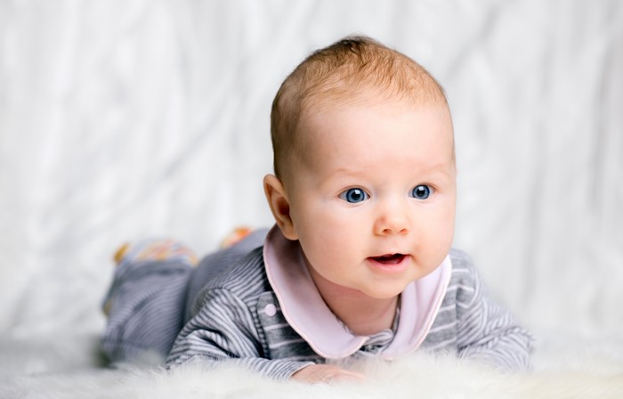 Baby lying on a fluffy white surface