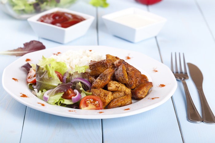 Chicken with rice and salad, ketchup and dip