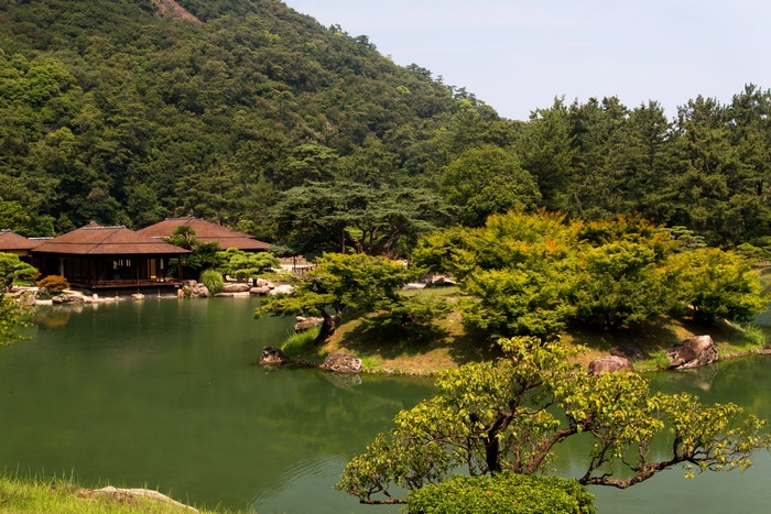 Ritsurin Garden with pond and traditional Japanese buildings