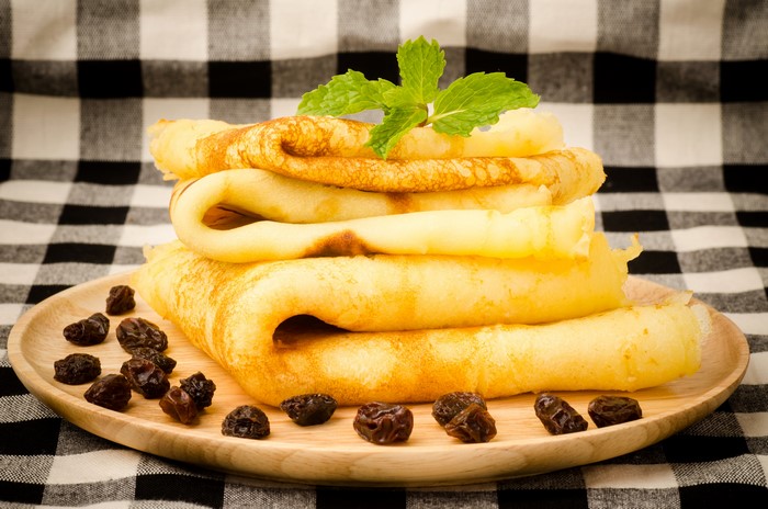 Pancakes with raisins and mint on a plate
