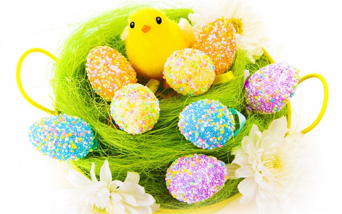Easter basket with decorated eggs and a chick