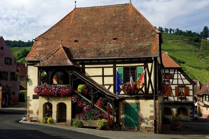 Half-timbered houses with flowers in Haut-Rhin, France