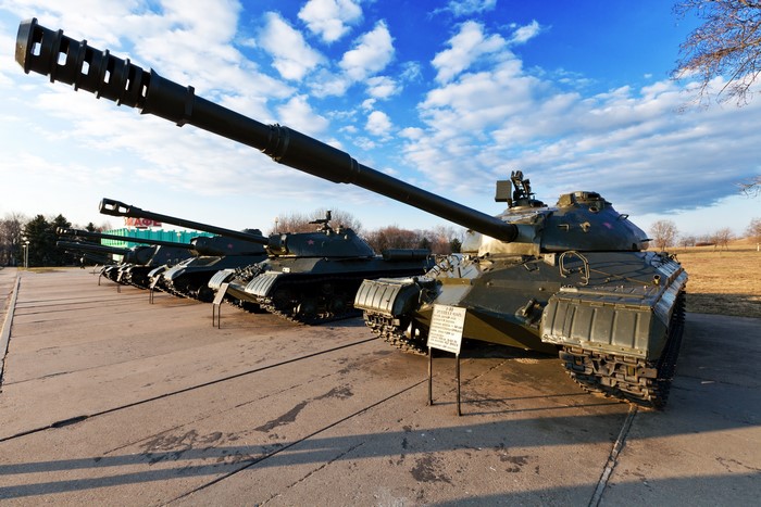 Soviet tanks on display under a cloudy sky