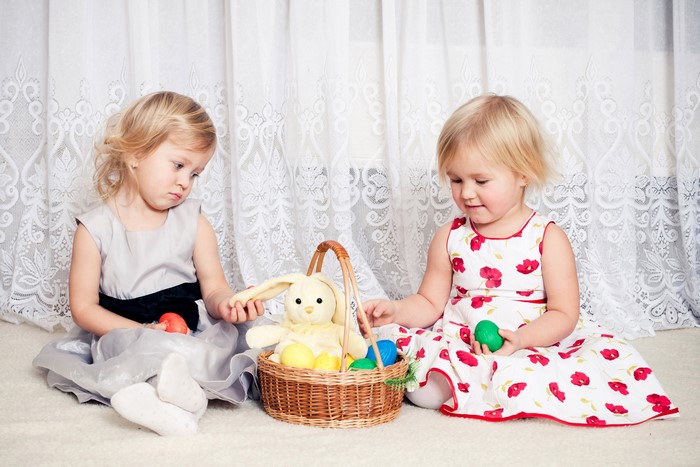 Two young girls with Easter basket and eggs