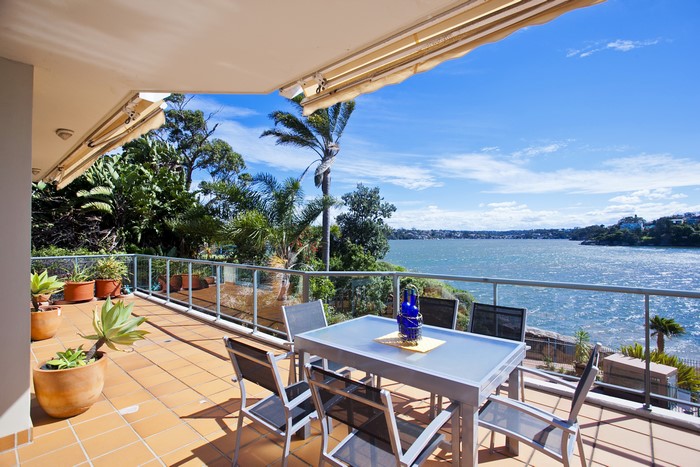 Balcony overlooking a wide river with lush greenery