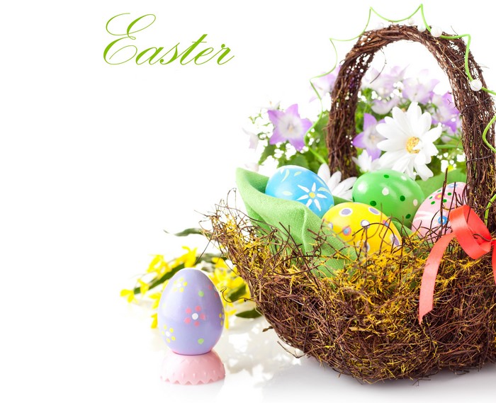 Easter eggs in a wicker basket with flowers