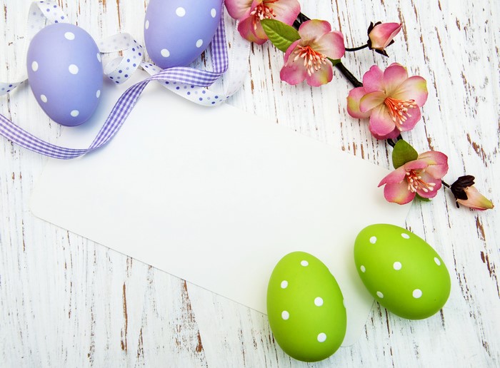 Easter eggs and flowers on a wooden background