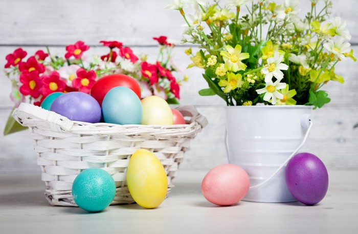Easter Eggs in Wicker Basket with Flowers