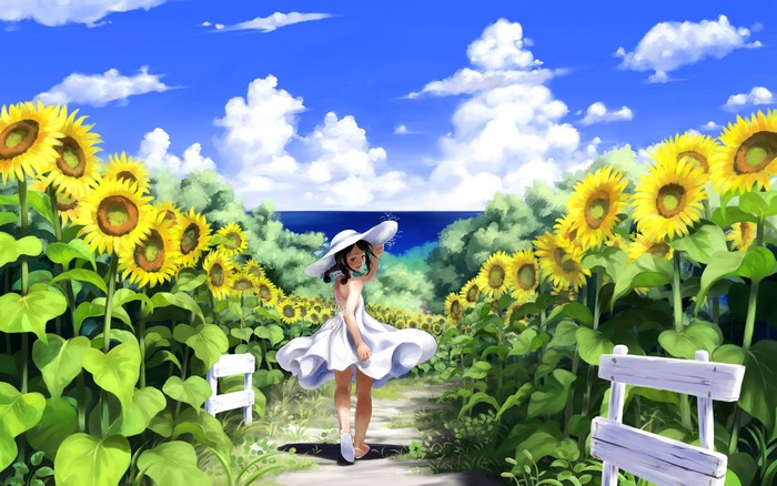 Girl in a sunflower field with a hat
