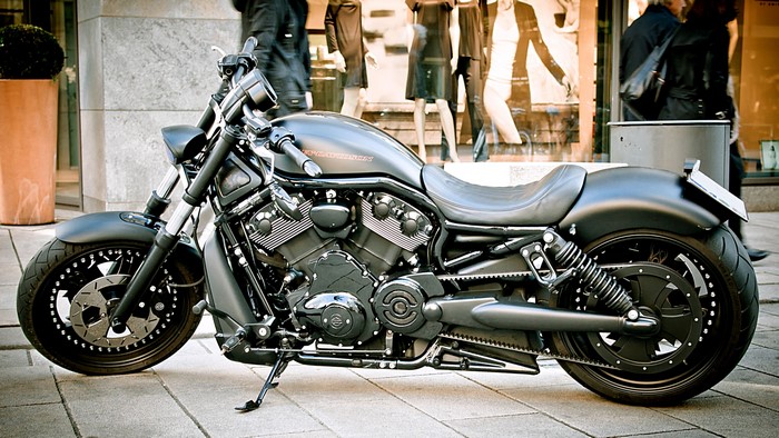 Black Harley-Davidson motorcycle parked on sidewalk