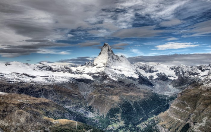 Matterhorn mountain range with snow and clouds