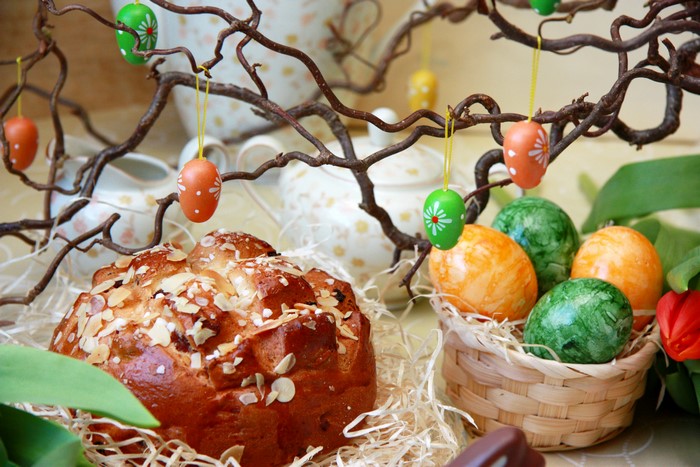 Easter bread and decorated eggs on branches
