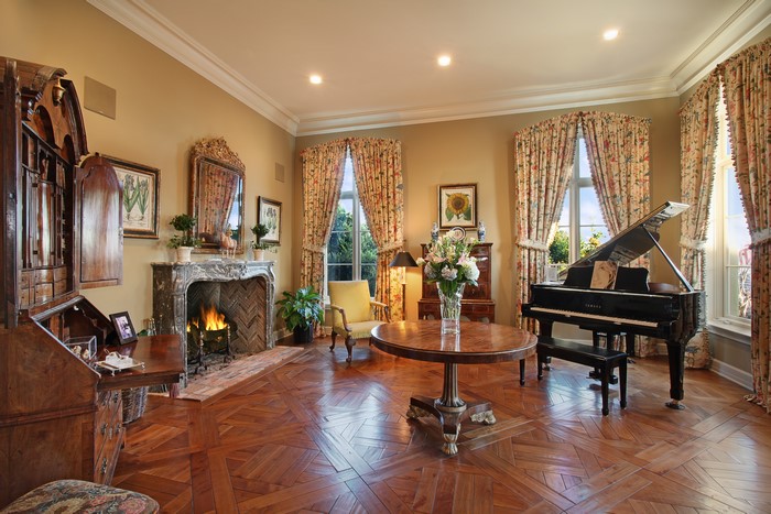Living room with grand piano and fireplace
