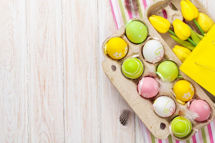 Easter Eggs and Yellow Tulips in Carton