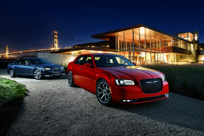 Two Chrysler 300 C cars at night near Golden Gate Bridge