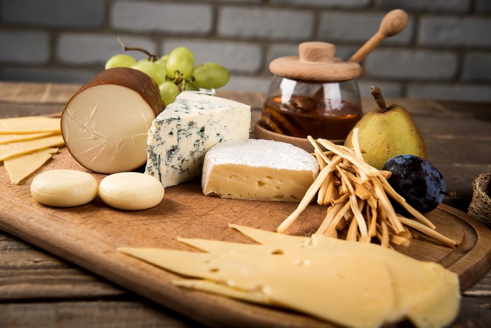 Cheese platter with fruits and honey