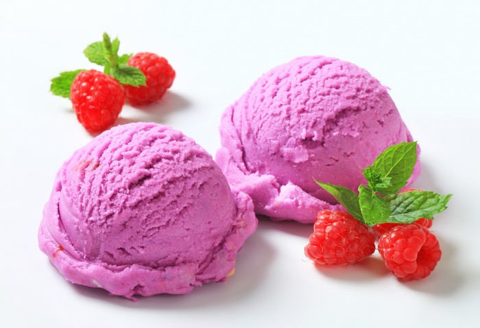 Raspberry ice cream scoops with fresh raspberries and mint
