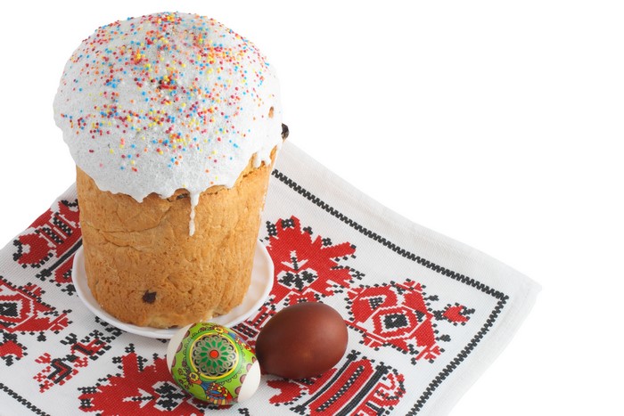 Easter Kulich with decorated eggs on embroidered cloth
