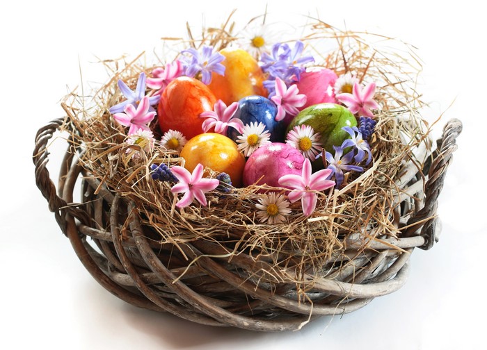 Easter eggs and flowers in a wicker basket
