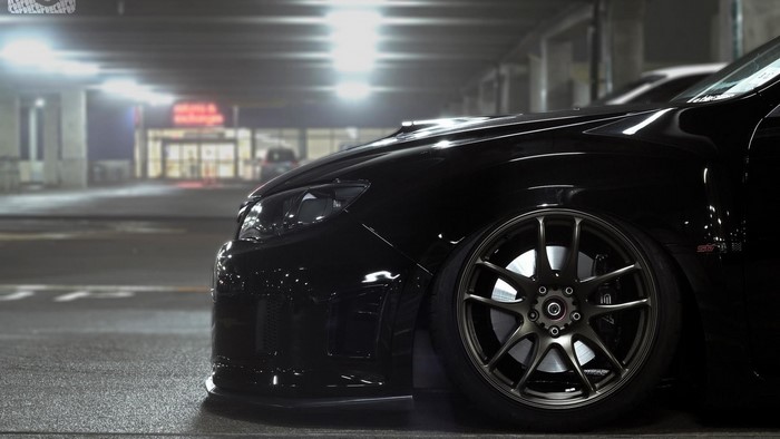 Black Subaru WRX STI in a parking garage