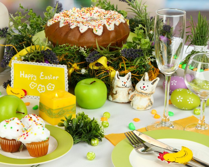 Easter table setting with cake, cupcakes, and decorations