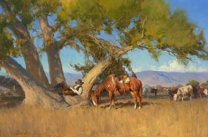 Cowboy resting under a tree with his horse and cattle