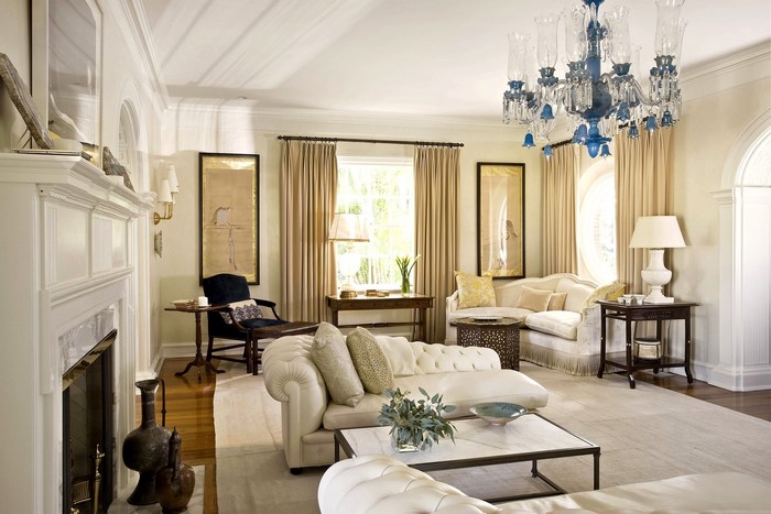 Elegant living room with tufted sofa and chandelier