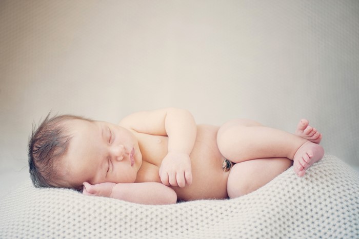 Newborn baby sleeping on a blanket