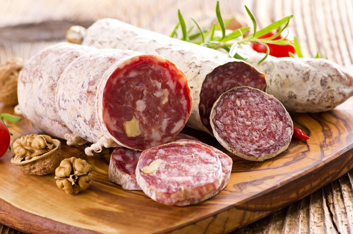 Sausage and walnuts on a wooden board