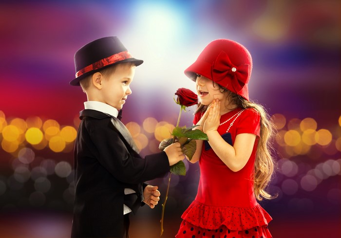 Boy in Tuxedo Gives Rose to Girl in Red Dress